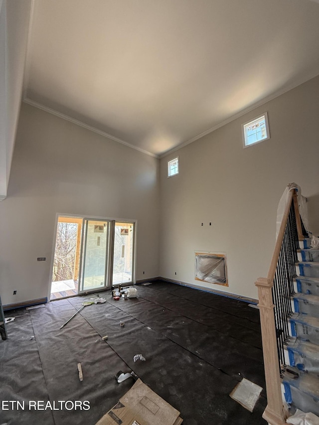 2412 Misty Mountain Cir, Knoxville, TN 37932 - unfurnished living room featuring a high ceiling, crown molding, and baseboards