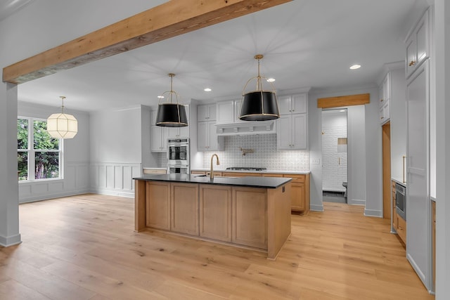 848 Brook Trl, Lebanon, TN 37087 - kitchen with a sink, light wood-style flooring, dark countertops, double oven, and recessed lighting