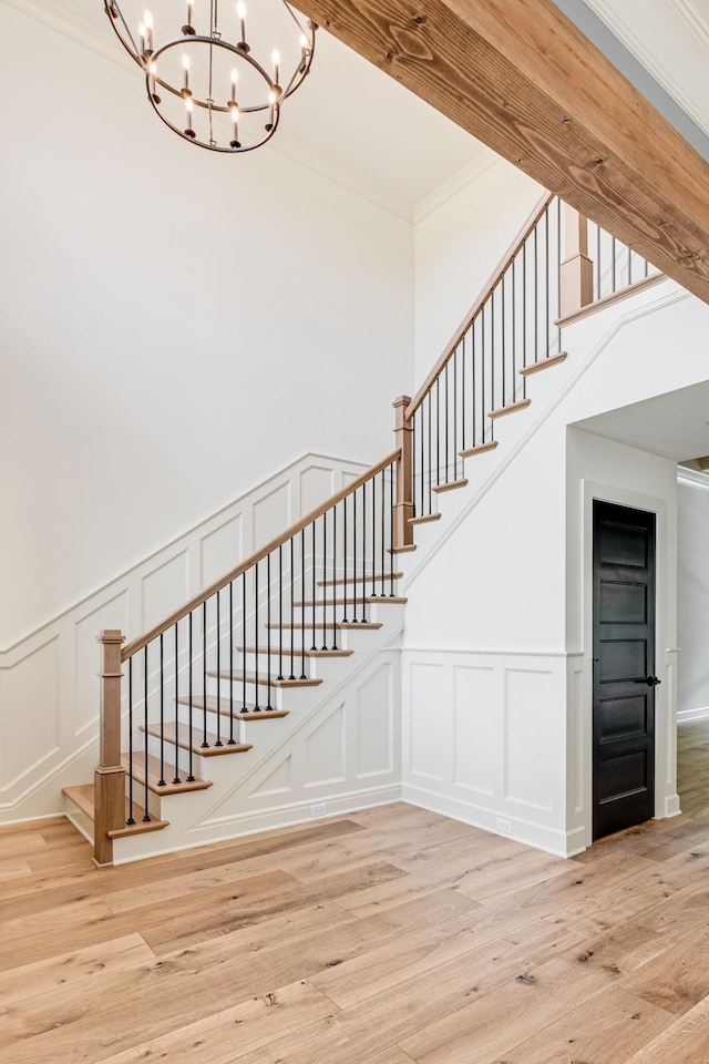 848 Brook Trl, Lebanon, TN 37087 - stairway featuring a decorative wall, a chandelier, crown molding, wood finished floors, and a wainscoted wall