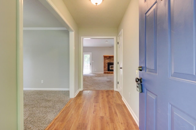 1420 E Rhett Butler Rd, Clarksville, TN 37042 - entryway featuring baseboards, a fireplace, light carpet, and light wood-type flooring