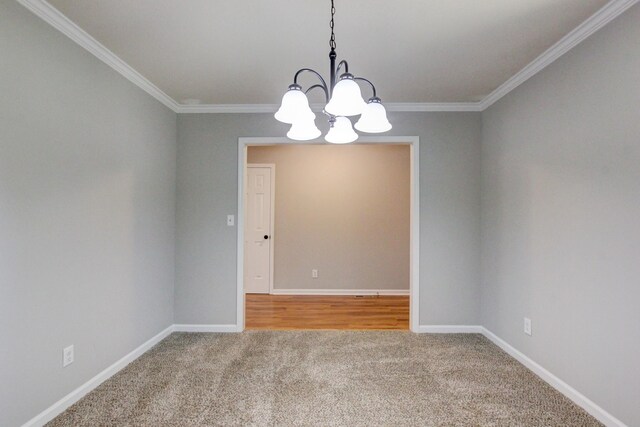 1420 E Rhett Butler Rd, Clarksville, TN 37042 - spare room with carpet flooring, a chandelier, ornamental molding, and baseboards