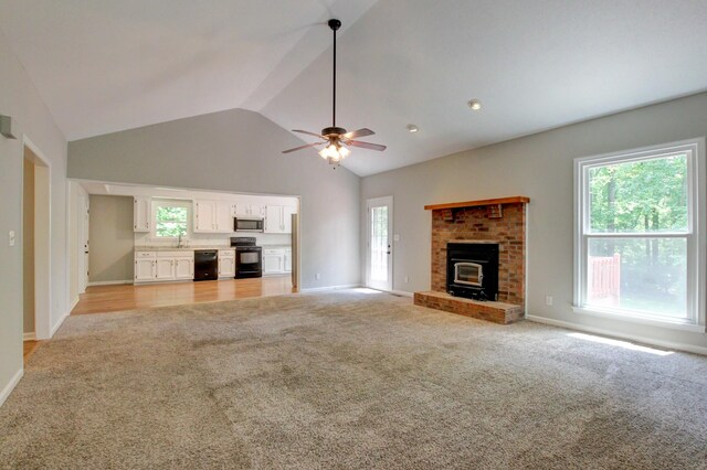 1420 E Rhett Butler Rd, Clarksville, TN 37042 - unfurnished living room featuring light colored carpet, a sink, vaulted ceiling, and healthy amount of natural light