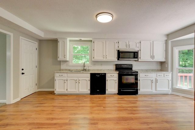 1420 E Rhett Butler Rd, Clarksville, TN 37042 - kitchen with black appliances, a sink, white cabinetry, and plenty of natural light