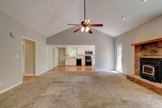 1420 E Rhett Butler Rd, Clarksville, TN 37042 - unfurnished living room with light carpet, ceiling fan, baseboards, high vaulted ceiling, and a brick fireplace