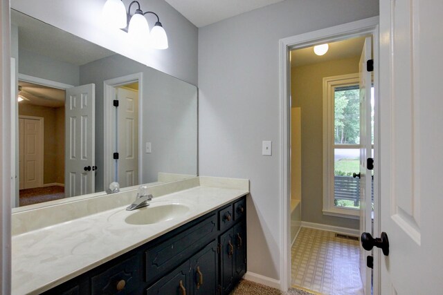 1420 E Rhett Butler Rd, Clarksville, TN 37042 - bathroom featuring baseboards, vanity, tile patterned floors, and a bathtub