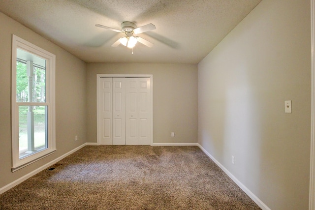 1420 E Rhett Butler Rd, Clarksville, TN 37042 - unfurnished bedroom featuring carpet, a closet, baseboards, a textured ceiling, and a ceiling fan