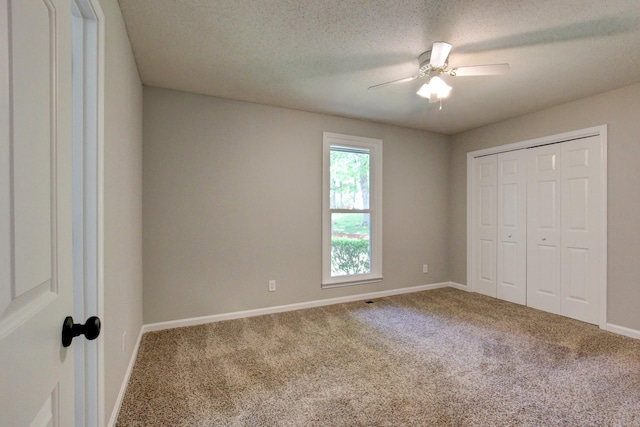 1420 E Rhett Butler Rd, Clarksville, TN 37042 - unfurnished bedroom featuring carpet, baseboards, a closet, a ceiling fan, and a textured ceiling
