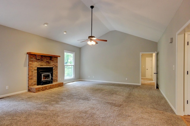 1420 E Rhett Butler Rd, Clarksville, TN 37042 - unfurnished living room featuring lofted ceiling, a ceiling fan, light colored carpet, a wood stove, and baseboards