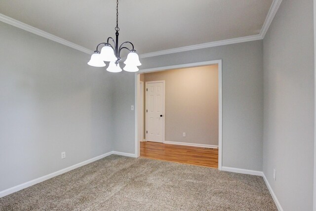 1420 E Rhett Butler Rd, Clarksville, TN 37042 - spare room featuring carpet floors, ornamental molding, a chandelier, and baseboards