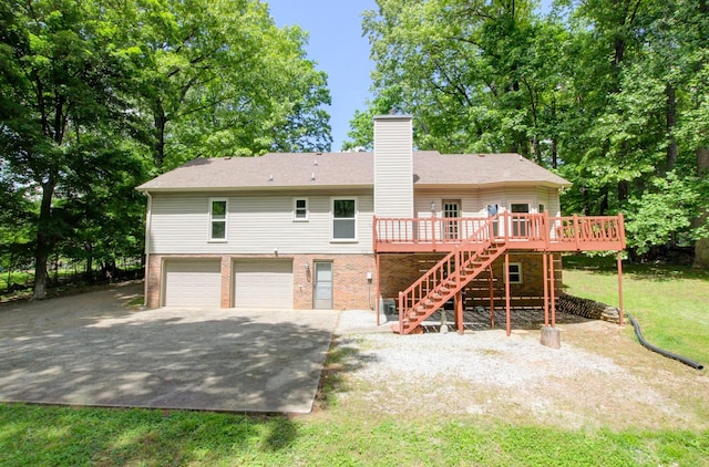 1420 E Rhett Butler Rd, Clarksville, TN 37042 - rear view of house with stairway, a deck, an attached garage, a chimney, and brick siding