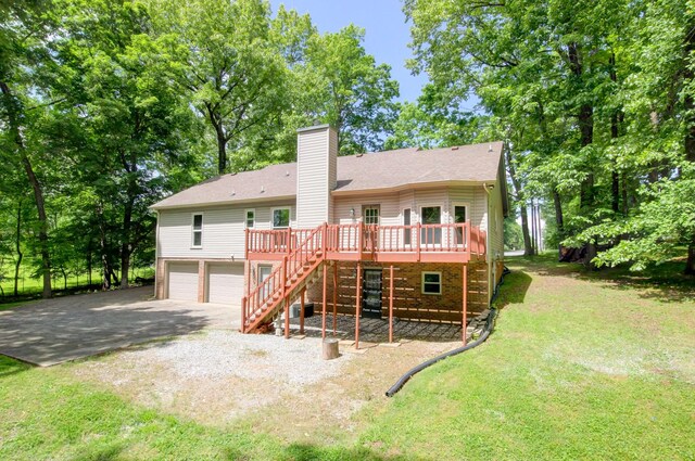 1420 E Rhett Butler Rd, Clarksville, TN 37042 - back of house with stairs, a deck, driveway, a chimney, and an attached garage