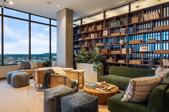 living area featuring a mountain view and floor to ceiling windows