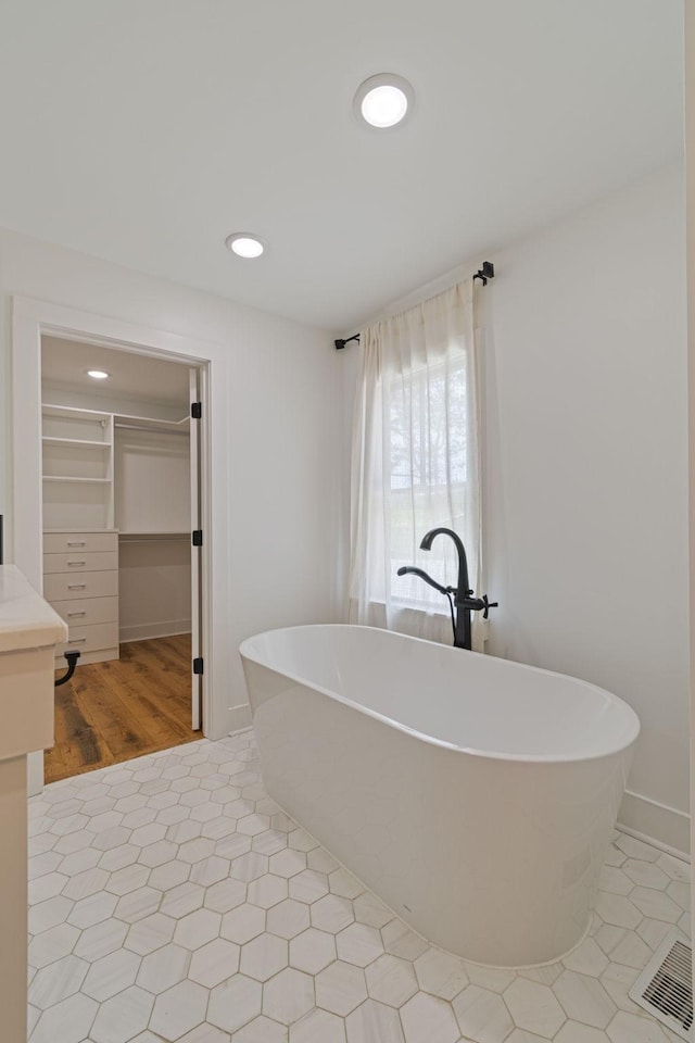 4824 Leipers Creek Rd, Williamsport, TN 38487 - bathroom featuring a spacious closet, a soaking tub, recessed lighting, baseboards, and tile patterned flooring