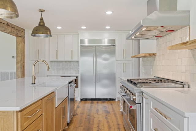 4824 Leipers Creek Rd, Williamsport, TN 38487 - kitchen featuring high end appliances, island exhaust hood, tasteful backsplash, dark wood finished floors, and recessed lighting