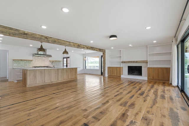 4824 Leipers Creek Rd, Williamsport, TN 38487 - unfurnished living room with a sink, recessed lighting, light wood-style flooring, and a fireplace