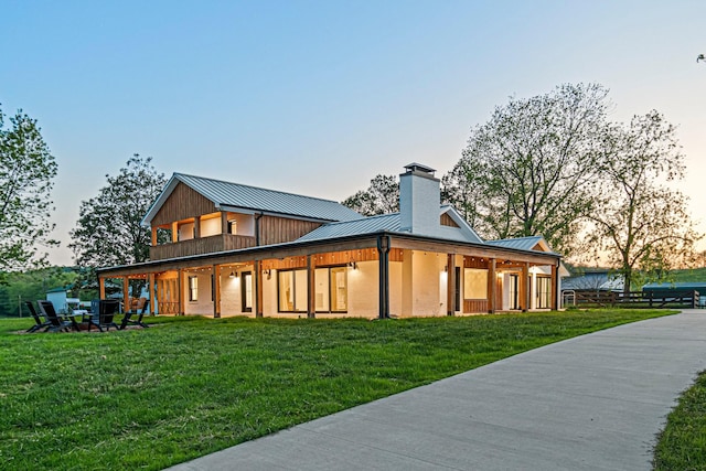 4824 Leipers Creek Rd, Williamsport, TN 38487 - rear view of house featuring a standing seam roof, metal roof, a chimney, and a yard