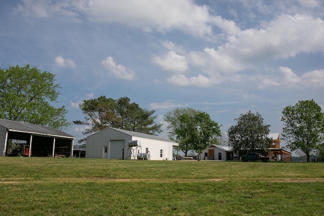 4824 Leipers Creek Rd, Williamsport, TN 38487 - view of green lawn with a pole building, a garage, and an outbuilding