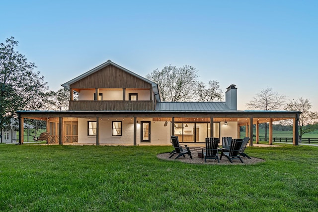 4824 Leipers Creek Rd, Williamsport, TN 38487 - back of property with a chimney, a lawn, an outdoor fire pit, metal roof, and a patio area
