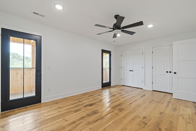 4824 Leipers Creek Rd, Williamsport, TN 38487 - unfurnished bedroom with multiple windows, two closets, light wood-style floors, and recessed lighting