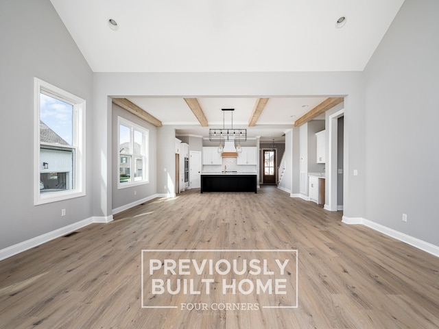 5517 Sinclair St, Murfreesboro, TN 37127 - unfurnished living room with light wood finished floors, healthy amount of natural light, and beamed ceiling