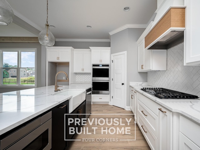 5517 Sinclair St, Murfreesboro, TN 37127 - kitchen featuring custom range hood, appliances with stainless steel finishes, white cabinetry, decorative backsplash, and crown molding