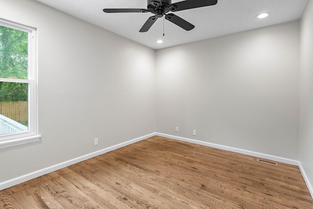 unfurnished room featuring baseboards, wood finished floors, a ceiling fan, and recessed lighting