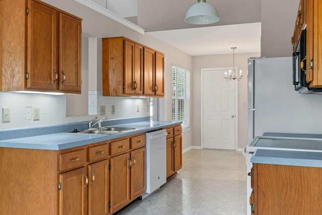 kitchen with white appliances, a sink, light flooring, tasteful backsplash, and brown cabinets