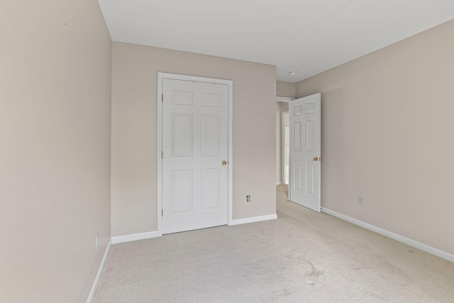 unfurnished bedroom with carpet and baseboards