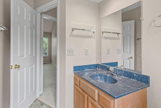 bathroom featuring baseboards and vanity