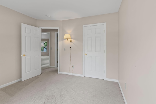 unfurnished bedroom featuring carpet flooring and baseboards