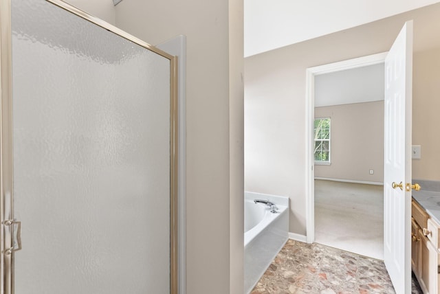 full bathroom featuring a shower stall, a bath, and baseboards
