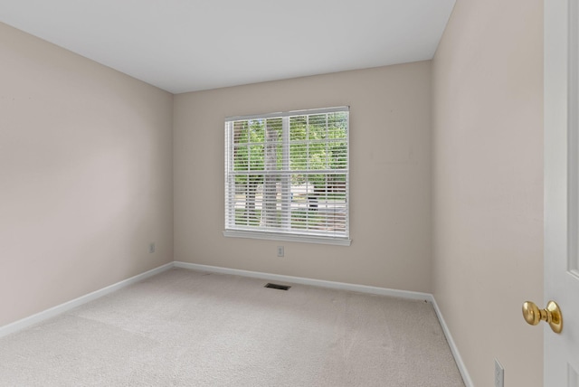 unfurnished room with baseboards and carpet flooring