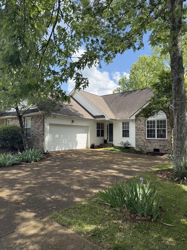 ranch-style home featuring an attached garage, driveway, brick siding, and a shingled roof