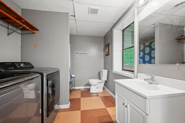 1015 Cross Country Dr, Kingston Springs, TN 37082 - bathroom featuring tile patterned floors, a paneled ceiling, toilet, separate washer and dryer, and vanity