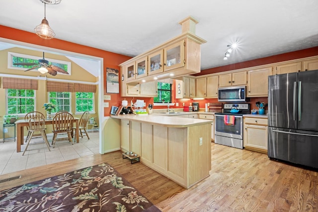 1015 Cross Country Dr, Kingston Springs, TN 37082 - kitchen featuring appliances with stainless steel finishes, a sink, ceiling fan, light wood-style floors, and a peninsula