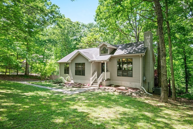1015 Cross Country Dr, Kingston Springs, TN 37082 - view of front of property with a chimney, a front yard, and central AC