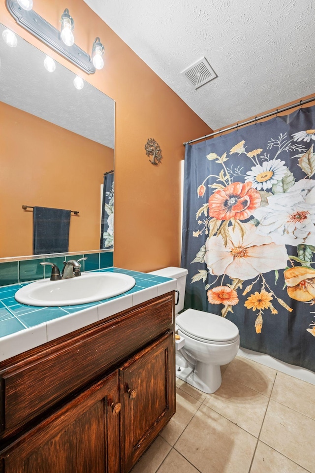 1015 Cross Country Dr, Kingston Springs, TN 37082 - bathroom featuring tile patterned flooring, toilet, vanity, and a textured ceiling