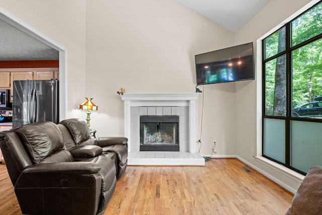 1015 Cross Country Dr, Kingston Springs, TN 37082 - living room with wood finished floors, lofted ceiling, and a tile fireplace