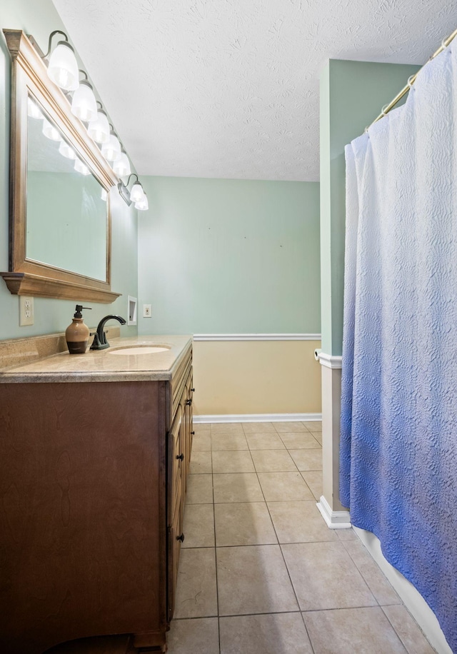 1015 Cross Country Dr, Kingston Springs, TN 37082 - bathroom with tile patterned floors, a textured ceiling, vanity, and baseboards