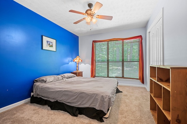 1015 Cross Country Dr, Kingston Springs, TN 37082 - carpeted bedroom with a textured ceiling, baseboards, a ceiling fan, and a closet