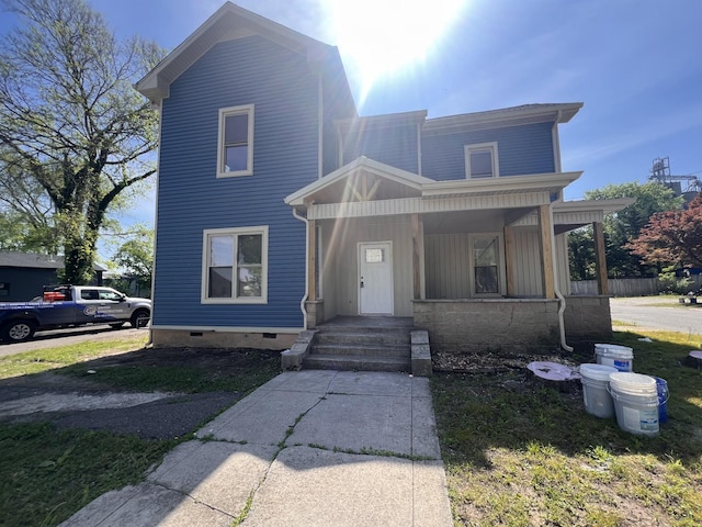 view of front of house featuring a porch and crawl space