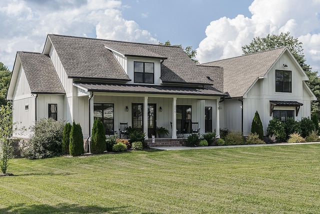 modern farmhouse style home with board and batten siding, covered porch, and a front yard