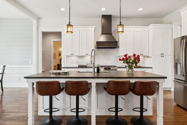273 Halltown Rd, Cottontown, TN 37048 - kitchen with wall chimney range hood, stainless steel fridge, a sink, white cabinetry, and pendant lighting