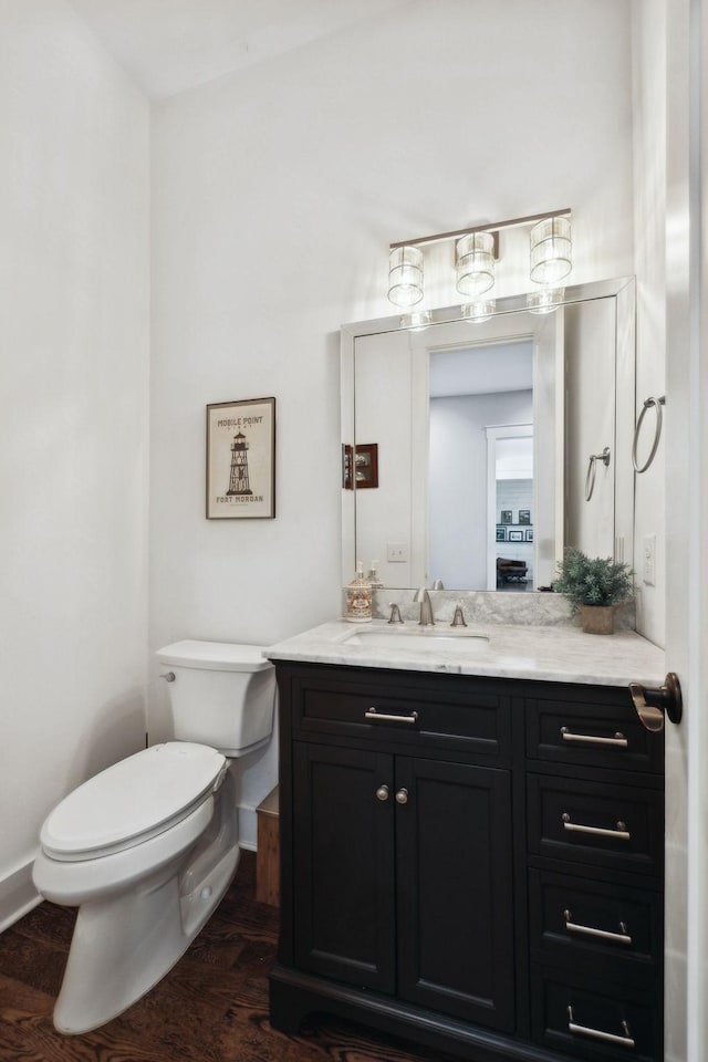 273 Halltown Rd, Cottontown, TN 37048 - half bathroom featuring toilet, vanity, baseboards, and wood finished floors