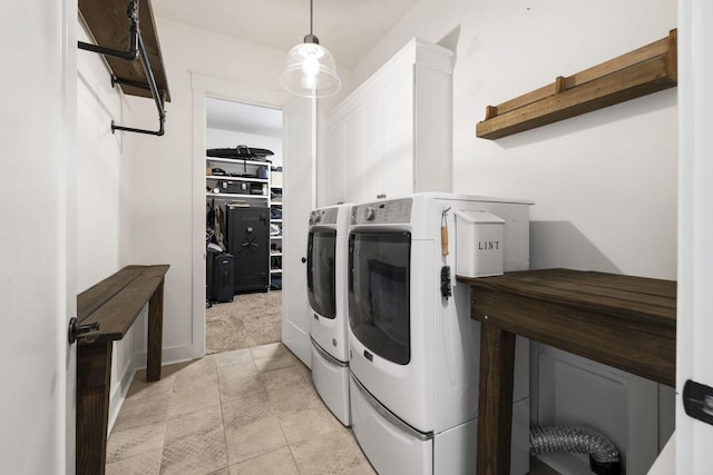 273 Halltown Rd, Cottontown, TN 37048 - laundry room featuring washing machine and dryer, cabinet space, light tile patterned floors, and light colored carpet