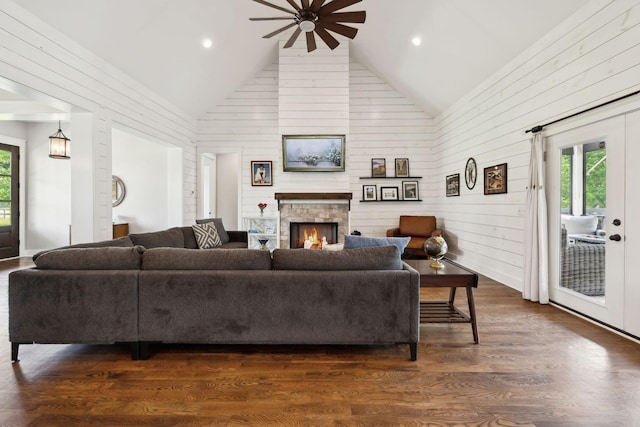 273 Halltown Rd, Cottontown, TN 37048 - living room with a ceiling fan, healthy amount of natural light, a lit fireplace, wood walls, and dark wood-style flooring