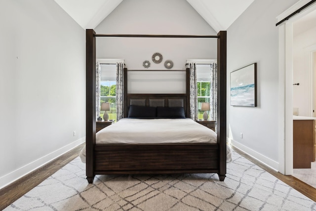 273 Halltown Rd, Cottontown, TN 37048 - bedroom with multiple windows, baseboards, vaulted ceiling, and wood finished floors
