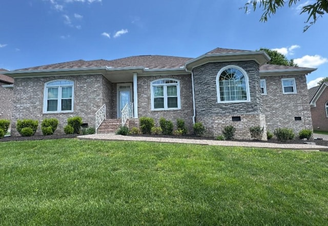 view of front of home featuring a front lawn, crawl space, and brick siding
