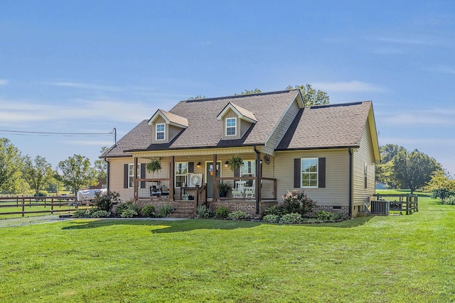 cape cod-style house featuring central AC, covered porch, and roof with shingles