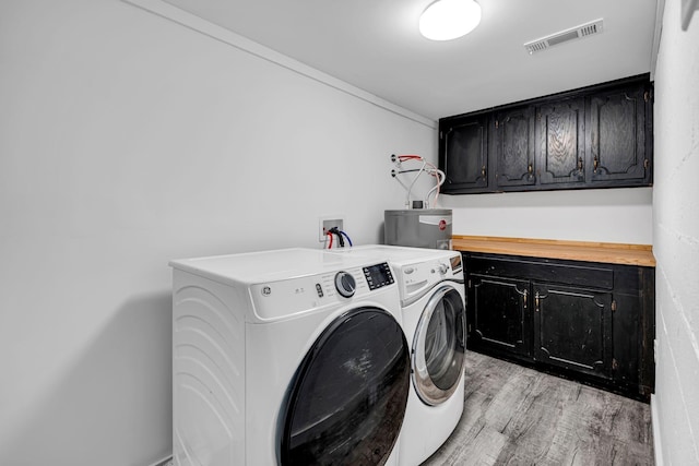 10 Grinnell Dr, Lawrenceburg, TN 38464 - laundry room with cabinet space, water heater, independent washer and dryer, and light wood-style floors